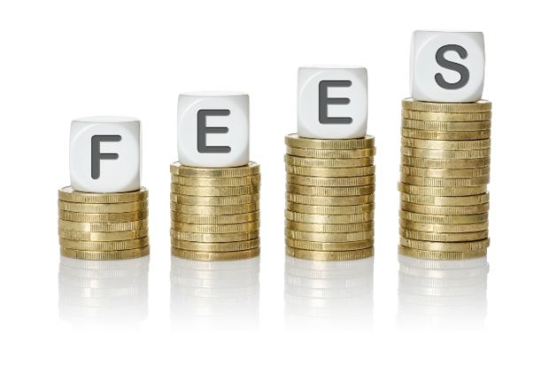 Four columns constructed from coins, with a letter of the word "FEES" atop each column, each letter represented by a dice. 