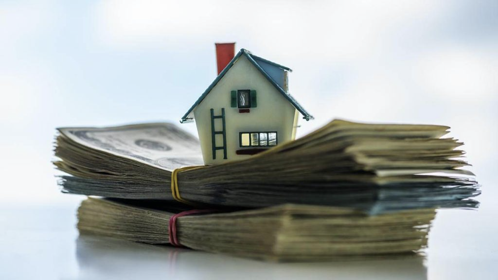 house emblem on stack of cash